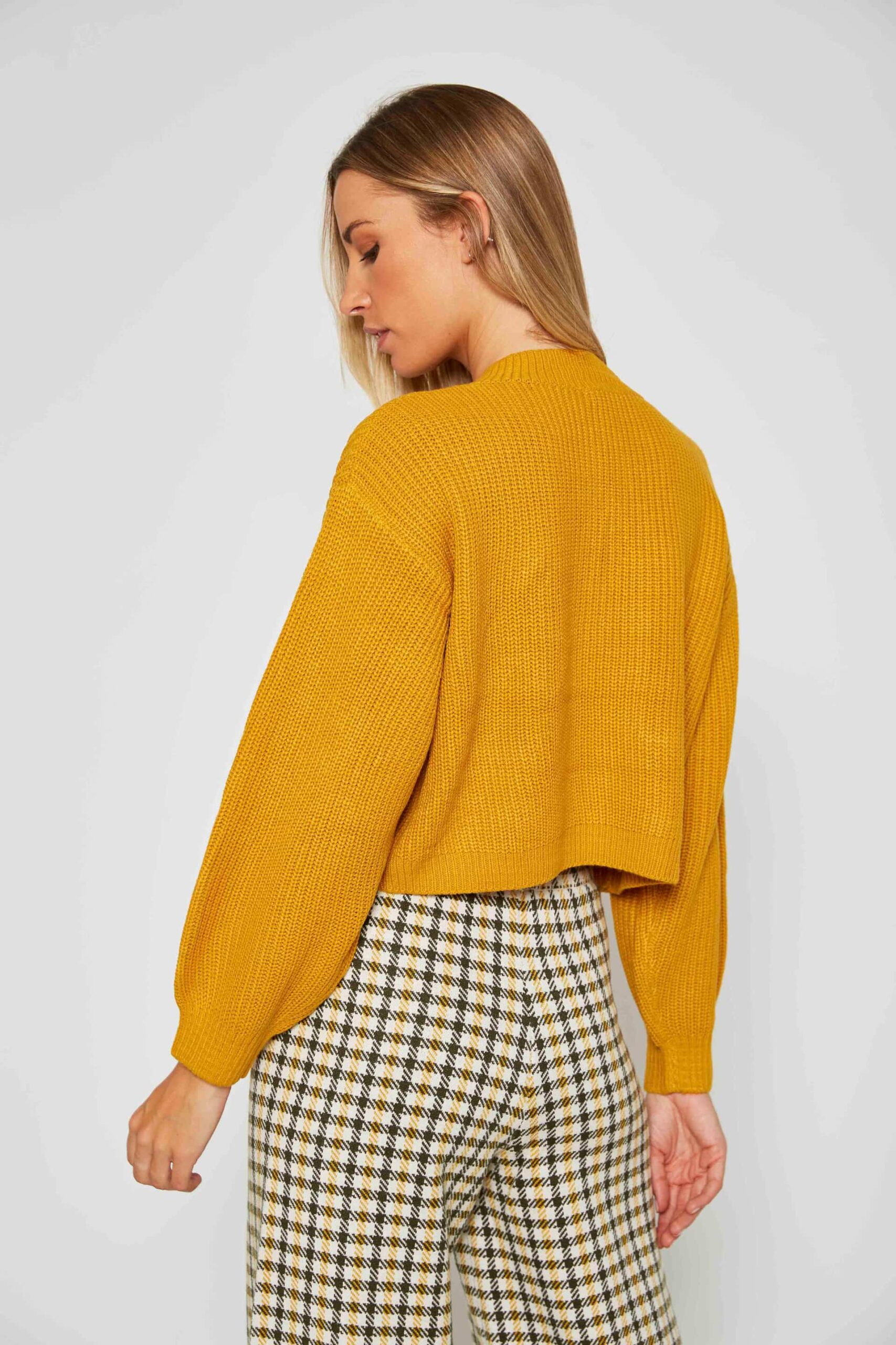 Knit sweater with woven pockets