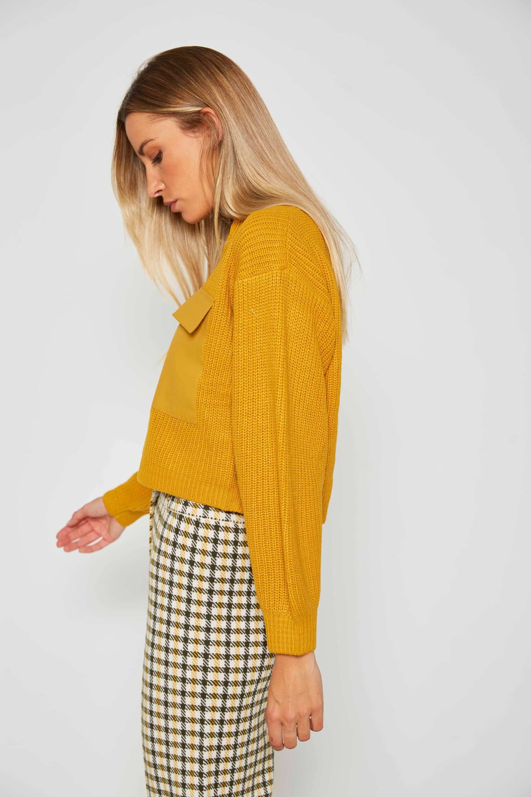 Knit sweater with woven pockets